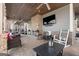 Relaxing outdoor living space featuring a stone fireplace, comfortable seating, and a mounted television for entertainment at 50 Birch Road, Covington, GA 30014