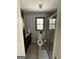 Bathroom with black and white patterned wallpaper, tiled flooring, glass-enclosed shower, and dark vanity at 125 Sir Lancelot Ct, Fayetteville, GA 30214