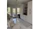 Cozy breakfast area with white marble table, chairs and cabinets near backyard access at 125 Sir Lancelot Ct, Fayetteville, GA 30214