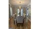 Bright dining room with modern wallpaper, neutral walls and curtains, and a long wood dining table at 125 Sir Lancelot Ct, Fayetteville, GA 30214