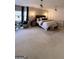 Spacious main bedroom featuring neutral decor, decorative lighting, and a cozy sitting area at 125 Sir Lancelot Ct, Fayetteville, GA 30214