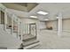 Spacious finished basement featuring neutral carpet, stairs, and decorative column at 118 Whitfield Run, Peachtree City, GA 30269