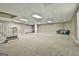 Finished basement with large open area, neutral carpet and built in shelving at 118 Whitfield Run, Peachtree City, GA 30269
