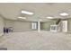 Spacious finished basement with neutral carpet, a pair of windows, and a double door at 118 Whitfield Run, Peachtree City, GA 30269