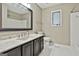 Bathroom with vanity, black hardware, and bright white tile flooring at 118 Whitfield Run, Peachtree City, GA 30269