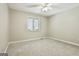 Neutral bedroom with carpet, ceiling fan, and large window to let in natural light at 118 Whitfield Run, Peachtree City, GA 30269
