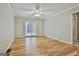 Bedroom with hardwood floors, ceiling fan, and sliding door access to outdoor space, perfect for relaxation at 118 Whitfield Run, Peachtree City, GA 30269