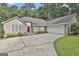 Stunning home with a two-car garage, beautiful landscaping, and a striking red front door at 118 Whitfield Run, Peachtree City, GA 30269