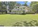 Exterior view of home featuring spacious backyard, upper deck, and lower patio at 118 Whitfield Run, Peachtree City, GA 30269