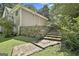 View of house exterior showing stone retaining wall and steps leading to upper level at 118 Whitfield Run, Peachtree City, GA 30269