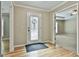 A bright foyer with hardwood floors, a patterned front door, and an open view to other rooms at 118 Whitfield Run, Peachtree City, GA 30269