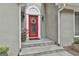 Elegant red front door with sidelights, a wreath, and decorative lights, adding charm and curb appeal at 118 Whitfield Run, Peachtree City, GA 30269