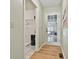 Hallway leading to laundry room and back door to garage with hardwood flooring and neutral paint at 118 Whitfield Run, Peachtree City, GA 30269