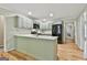 Stylish kitchen with green cabinets, quartz countertops, and stainless steel appliances, perfect for cooking at 118 Whitfield Run, Peachtree City, GA 30269