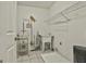 Well-lit laundry room with utility sink and shelving to keep cleaning supplies tidy and organized at 118 Whitfield Run, Peachtree City, GA 30269