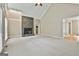Inviting living room with a stone fireplace, neutral carpet, and view to connecting spaces, offering a cozy atmosphere at 118 Whitfield Run, Peachtree City, GA 30269