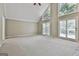 Open living room with high ceilings, large windows, and sliding glass doors, creating a bright and airy space at 118 Whitfield Run, Peachtree City, GA 30269