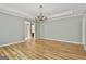 Bright living room featuring hardwood floors and a decorative chandelier, offering classic charm at 118 Whitfield Run, Peachtree City, GA 30269