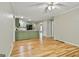 Open-concept living area with hardwood floors seamlessly connecting the kitchen and living spaces for modern living at 118 Whitfield Run, Peachtree City, GA 30269