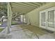 Covered patio featuring concrete floors, exterior access, and stairwell to upper deck at 118 Whitfield Run, Peachtree City, GA 30269
