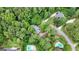 Aerial view of a home surrounded by trees, highlighting access to swimming pools and green lawns in this neighborhood at 1290 Shadowlawn Ne Dr, Conyers, GA 30012