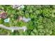 An aerial view of a home surrounded by dense greenery, with a glimpse of nearby swimming pools and neighborhood streets at 1290 Shadowlawn Ne Dr, Conyers, GA 30012