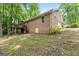 Exterior view of the back of the house, featuring a brick facade, walk out basement, and deck at 1290 Shadowlawn Ne Dr, Conyers, GA 30012