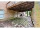 Backyard featuring an elevated wooden deck, brick facade and stone patio at 1290 Shadowlawn Ne Dr, Conyers, GA 30012