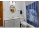 Bathroom with white walls, toilet, sink with cabinets, round mirror and shower with space-themed curtain at 1290 Shadowlawn Ne Dr, Conyers, GA 30012