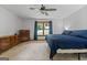 Bright bedroom with neutral carpet, ceiling fan, window and classic wood dresser at 1290 Shadowlawn Ne Dr, Conyers, GA 30012