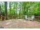 Outdoor deck surrounded by lush trees, perfect for relaxation and enjoying nature at 1290 Shadowlawn Ne Dr, Conyers, GA 30012