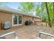 Outdoor deck with a grill, french doors, and serene view of the surrounding greenery at 1290 Shadowlawn Ne Dr, Conyers, GA 30012