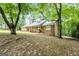 Charming brick home with a front porch and inviting curb appeal nestled among mature trees at 1290 Shadowlawn Ne Dr, Conyers, GA 30012