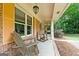 Welcoming front porch features rocking chairs and ample space for outdoor seating and relaxation at 1290 Shadowlawn Ne Dr, Conyers, GA 30012