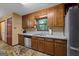 Well-lit kitchen with stainless steel appliances, wood cabinets, and unique stone flooring at 1290 Shadowlawn Ne Dr, Conyers, GA 30012