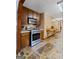 Well-equipped kitchen featuring stainless steel appliances, wood cabinets, and stone flooring at 1290 Shadowlawn Ne Dr, Conyers, GA 30012