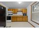 Kitchen features wood cabinets, laminate countertops, and white appliances at 1290 Shadowlawn Ne Dr, Conyers, GA 30012