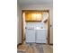 Convenient laundry room with washer, dryer, and wooden cabinets for storage at 1290 Shadowlawn Ne Dr, Conyers, GA 30012