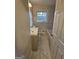 Bathroom with a tiled shower, marble floors, new vanity, a window, and white door at 655 Shellnut Dr, Forest Park, GA 30297