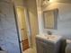 Modern bathroom with sleek vanity, mirror, and marble tile at 655 Shellnut Dr, Forest Park, GA 30297