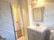 Bathroom featuring a white marble shower and a new vanity at 655 Shellnut Dr, Forest Park, GA 30297