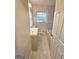 Well-lit bathroom features neutral color palette, tile flooring and shower surround and modern sink at 655 Shellnut Dr, Forest Park, GA 30297