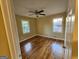 Bedroom features hardwood floors, neutral walls, and two windows providing natural light at 655 Shellnut Dr, Forest Park, GA 30297