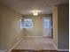 Bright dining area with tile floors, neutral walls, updated lighting fixture, and entry door at 655 Shellnut Dr, Forest Park, GA 30297