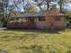 Charming brick home featuring a well-maintained lawn and a cozy front porch with wood railings at 655 Shellnut Dr, Forest Park, GA 30297