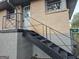 Brick home's exterior with a metal staircase leading to the front door at 655 Shellnut Dr, Forest Park, GA 30297