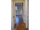 Hallway with rich hardwood flooring leads to adjacent rooms showcasing the home's layout at 655 Shellnut Dr, Forest Park, GA 30297