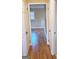 Hallway with hardwood floors and two open doors at 655 Shellnut Dr, Forest Park, GA 30297