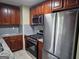 Renovated kitchen with stainless appliances, stone countertops, and warm wood cabinets at 655 Shellnut Dr, Forest Park, GA 30297