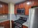 Well-equipped kitchen featuring stainless steel appliances, granite countertops, and stylish wooden cabinetry at 655 Shellnut Dr, Forest Park, GA 30297